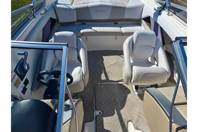 Slide: The Image of 2007 Larson LXi 228 boat interior with plush seating and steering wheel. - 20