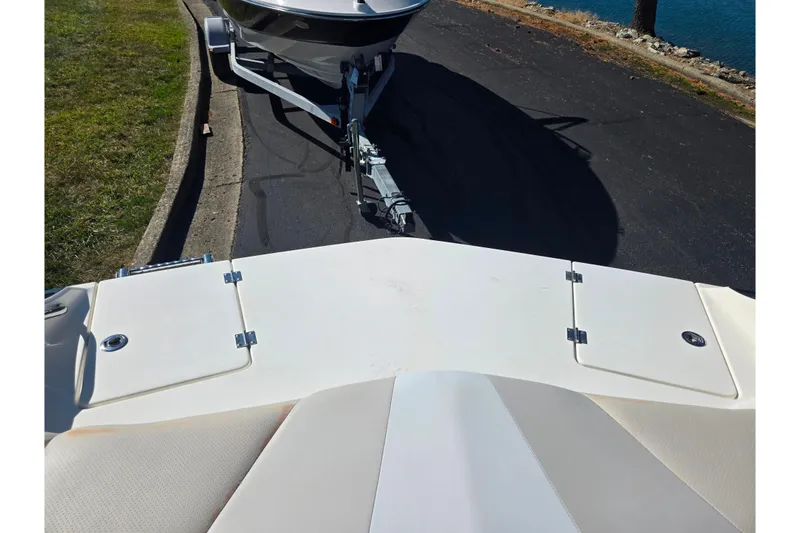 Slide: The Image of 2007 Larson LXi 228 boat on trailer near water, viewed from the deck. - 25
