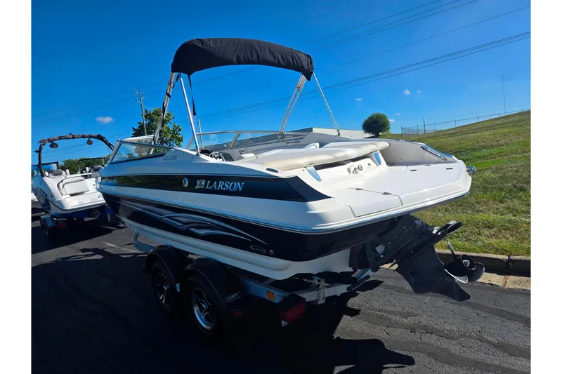 Slide: The Image of 2007 Larson LXi 228 boat on trailer, sunny day, grassy background. - 3