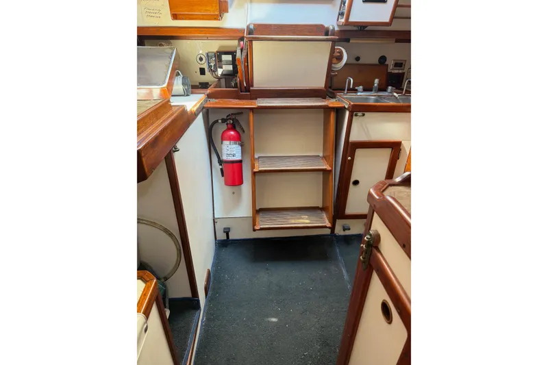 Slide: The Image of 1981 Kaiser 34' Gale Force offshore cutter bathroom with sink, mirror, and wooden accents. - 21