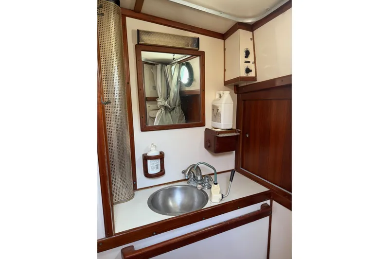 Slide: The Image of Interior of 1981 Kaiser 34' Gale Force offshore cutter with wooden paneling and storage. - 23