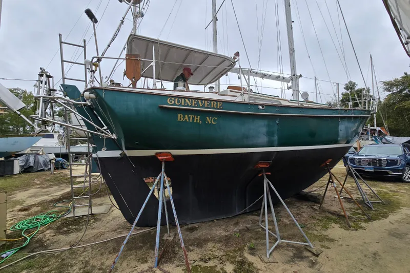 Slide: The Image of 1981 Kaiser 34' Gale Force offshore cutter sailboat on land, surrounded by other boats. - 32