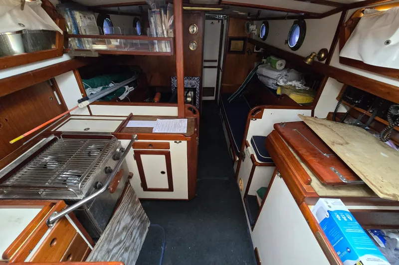 Slide: The Image of Interior of 1981 Kaiser 34' Gale Force offshore cutter, featuring wood paneling and nautical decor. - 43