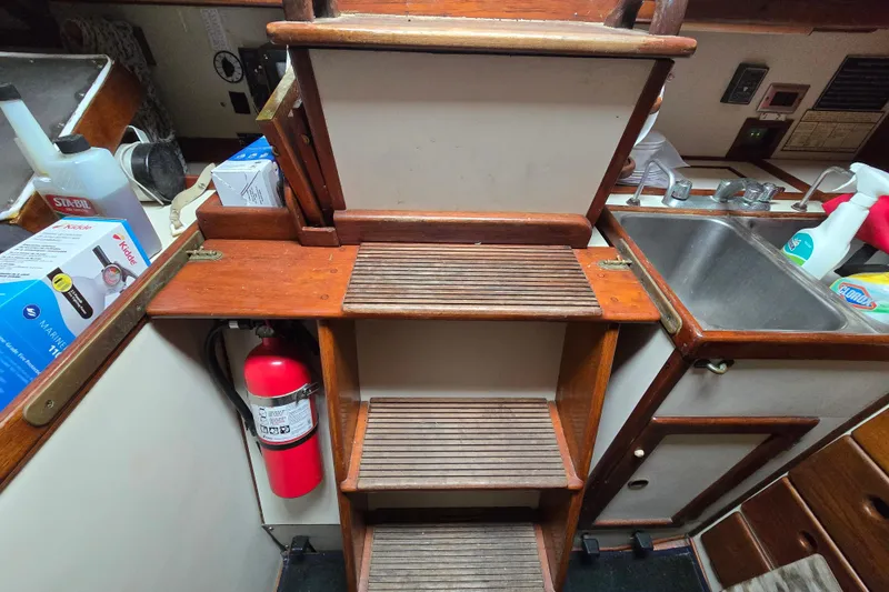 Slide: The Image of Interior of 1981 Kaiser 34' Gale Force offshore cutter, featuring wooden cabinetry and cozy living space. - 49