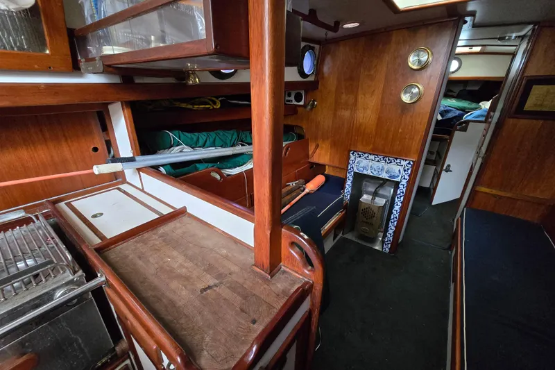 Slide: The Image of Open storage compartment on 1981 Kaiser 34' Gale Force cutter with equipment and warning sign. - 52