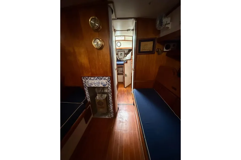 Slide: The Image of Interior of 1981 Kaiser 34' Gale Force offshore cutter, featuring cozy cabin and wooden flooring. - 9