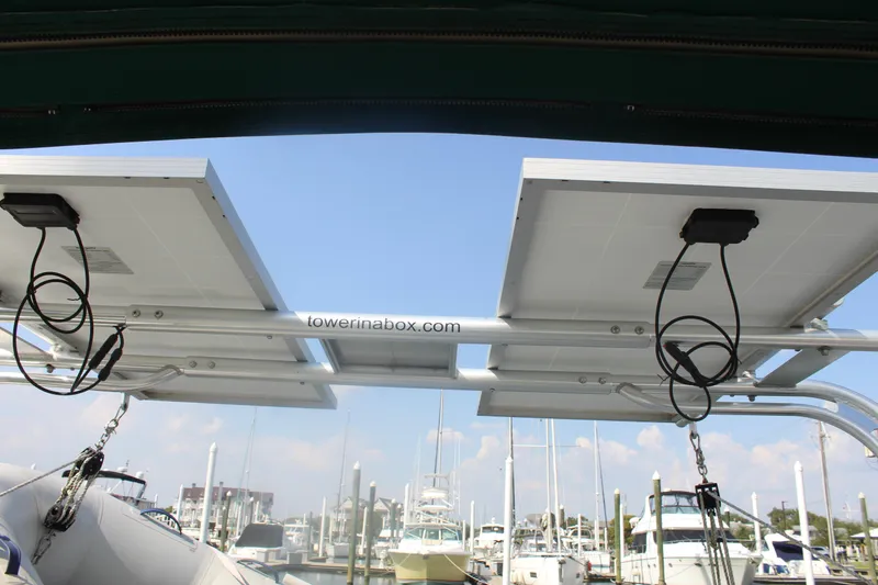 Slide: The Image of Solar panels on a 2001 Beneteau 411 sailboat, docked at a marina. - 10