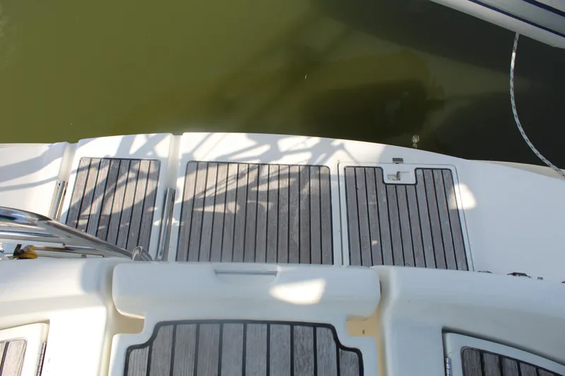 Slide: The Image of Beneteau 411 (2001) yacht deck with wooden panels and water reflection. - 12