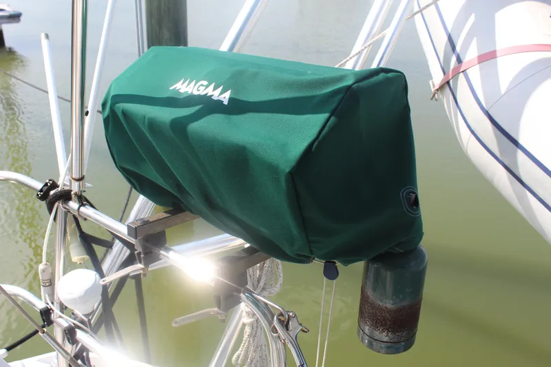 Slide: The Image of Green Magma grill cover on Beneteau 411 sailboat, 2001 model, docked by water. - 13