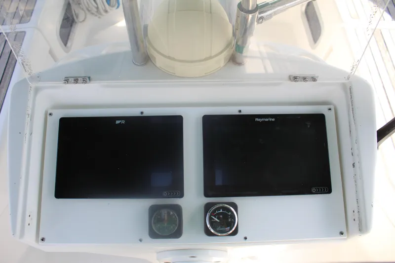 Slide: The Image of Beneteau 411 yacht dashboard with Raymarine displays and compass, 2001 model. - 15