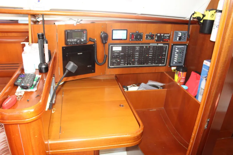 Slide: The Image of Navigation station of a 2001 Beneteau 411 sailboat with control panels and equipment. - 21