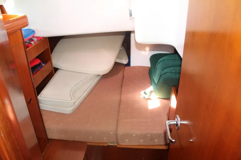 Slide: The Image of Interior cabin of 2001 Beneteau 411 sailboat with cushions and storage shelves. - 23