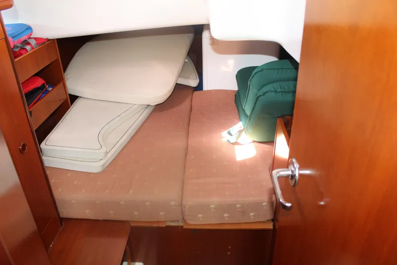 Slide: The Image of Cozy cabin interior of 2001 Beneteau 411 sailboat with cushions and storage. - 24
