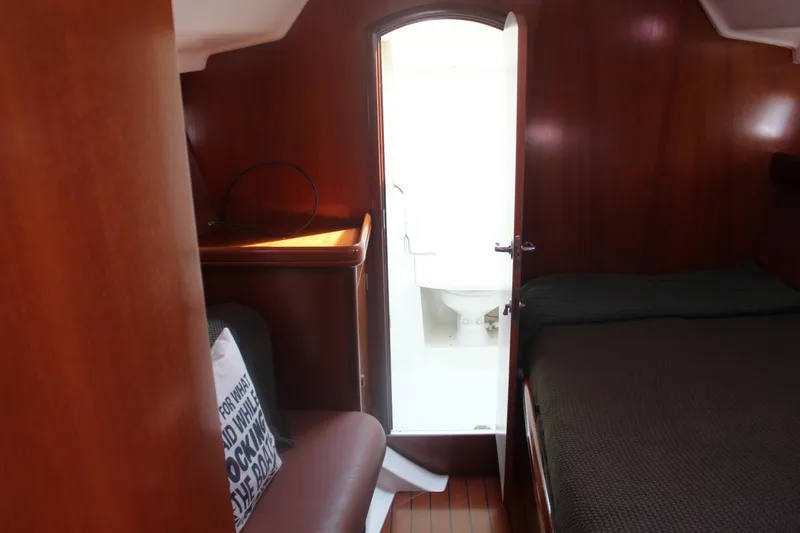 Slide: The Image of Interior of 2001 Beneteau 411 yacht cabin with wooden finish and visible bathroom. - 29