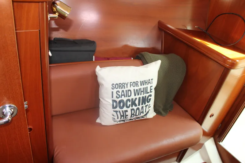 Slide: The Image of Cozy interior of 2001 Beneteau 411 with humorous pillow on leather seat. - 30