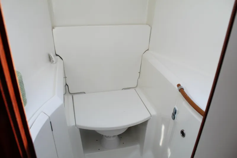 Slide: The Image of 2001 Beneteau 411 yacht bathroom with compact white toilet and sleek design. - 31