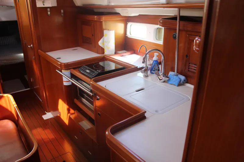 Slide: The Image of Interior of 2001 Beneteau 411 yacht kitchen with wood cabinetry and modern appliances. - 35