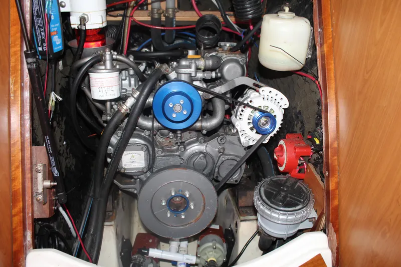 Slide: The Image of Engine compartment of a 2001 Beneteau 411 sailboat, showcasing mechanical components and wiring. - 36