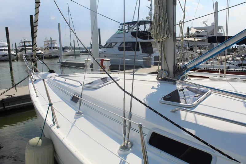 Slide: The Image of Sailboat Beneteau 411, 2001 model, docked at marina with other boats. - 39
