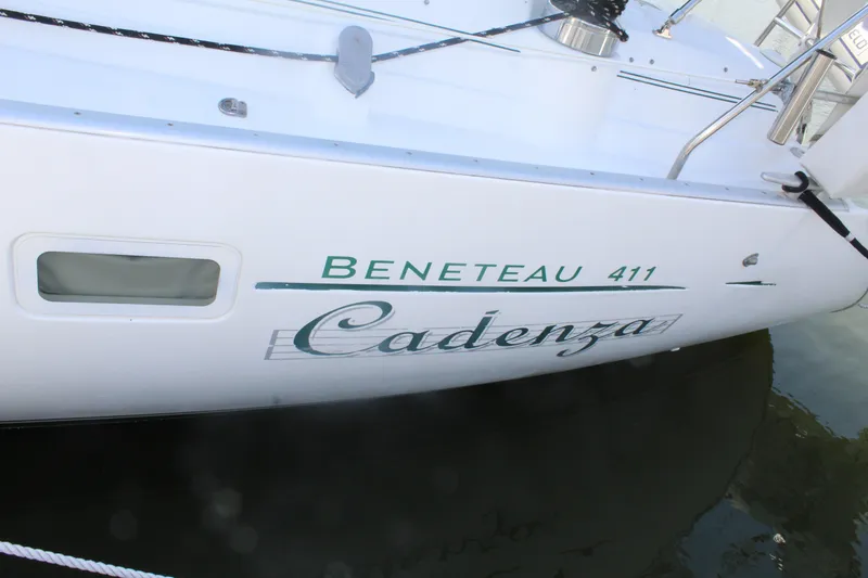 Slide: The Image of Beneteau 411 sailboat named Cadenza, 2001 model, docked on calm water. - 40