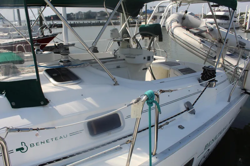 Slide: The Image of 2001 Beneteau 411 sailboat docked, featuring a clean deck and visible rigging. - 7