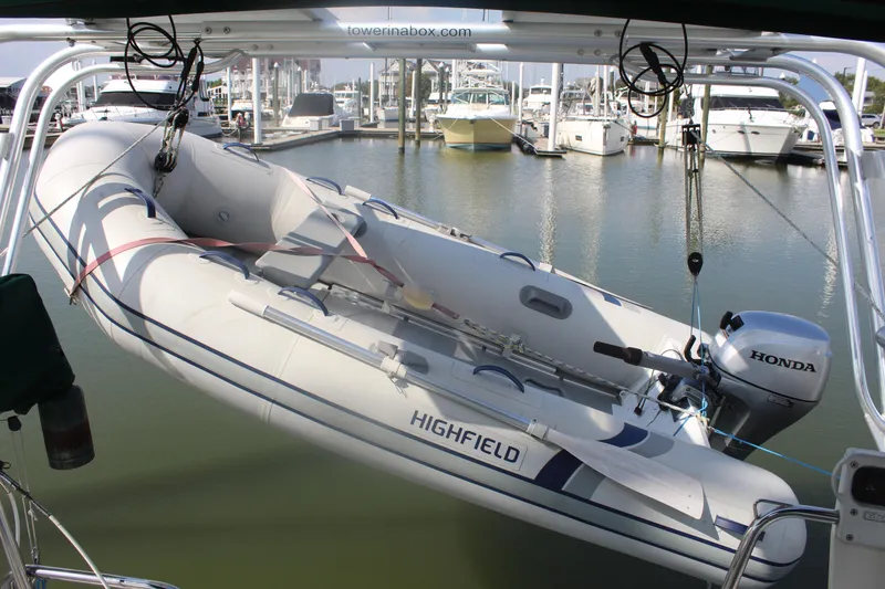 Slide: The Image of Inflatable boat with Honda motor on Beneteau 411, 2001 model, docked at marina. - 9