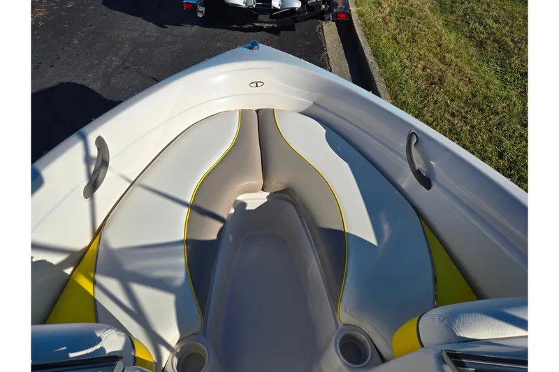 Slide: The Image of 2006 Tahoe Q4 Sport boat interior with yellow and white seating. - 16