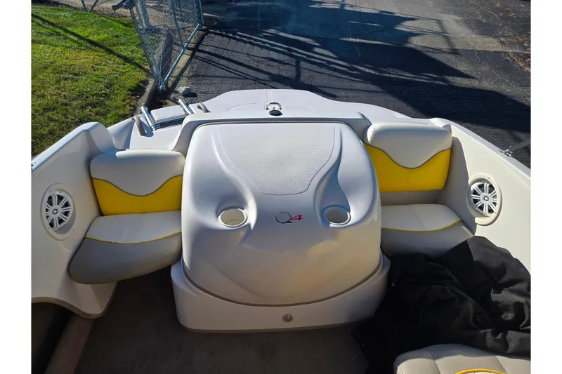 Slide: The Image of 2006 Tahoe Q4 Sport boat interior with yellow and white seating, cup holders, and speakers. - 20
