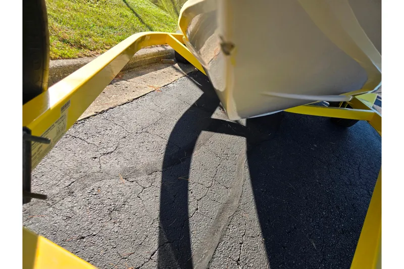 Slide: The Image of Yellow trailer holding a covered 2006 Tahoe Q4 Sport boat on a sunny day. - 7