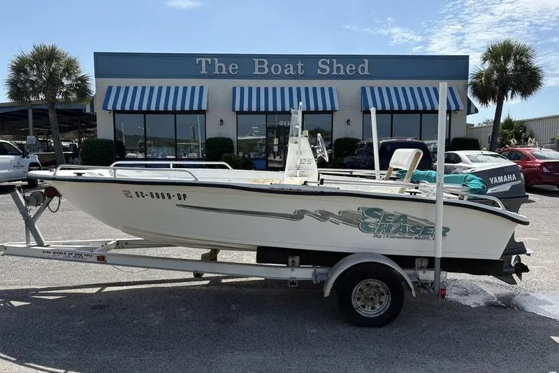 Slide: The Image of 2004 Carolina Skiff 175 boat on trailer outside The Boat Shed dealership. - 0