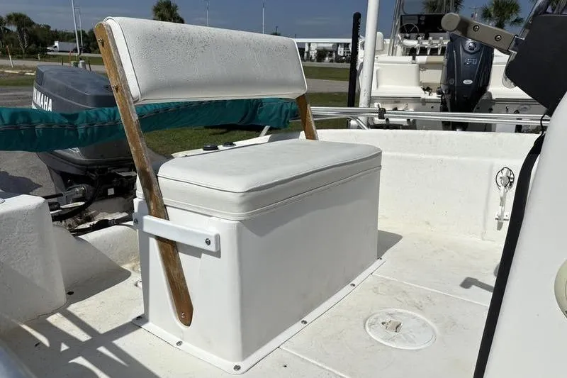 Slide: The Image of 2004 Carolina Skiff 175 boat seat with storage, featuring a Yamaha outboard motor. - 10