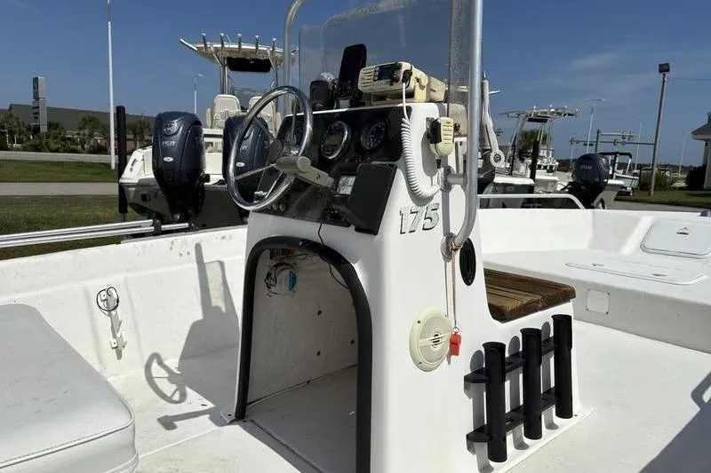 Slide: The Image of 2004 Carolina Skiff 175 boat console with steering wheel and controls. - 11
