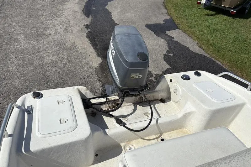 Slide: The Image of 2004 Carolina Skiff 175 boat with Yamaha 90 outboard motor on a paved surface. - 13