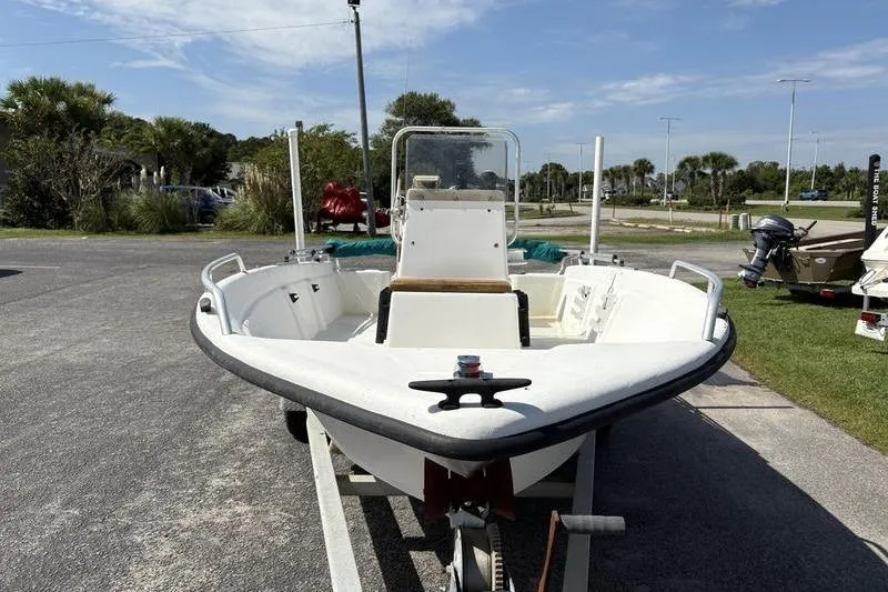 Slide: The Image of 2004 Carolina Skiff 175 boat on trailer, parked outdoors under clear sky. - 4