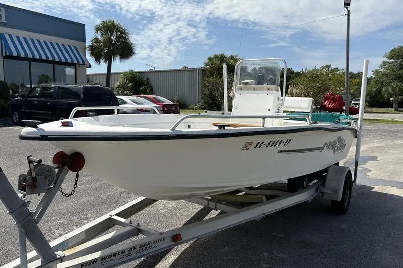Slide: The Image of 2004 Carolina Skiff 175 boat on trailer in parking lot, sunny day. - 5
