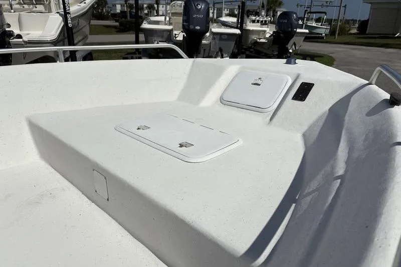 Slide: The Image of 2004 Carolina Skiff 175 boat interior with storage compartments and clean white finish. - 8