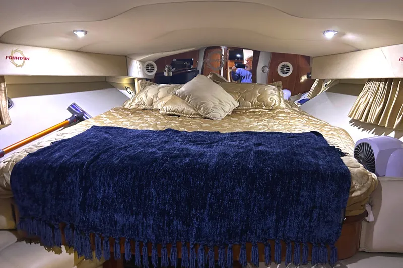 Slide: The Image of Luxurious cabin interior of a 2005 Fountain 48 Express Cruiser with plush bedding. - 10