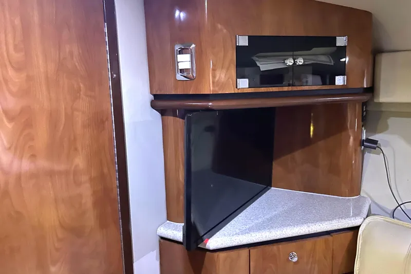 Slide: The Image of Interior of 2005 Fountain 48 Express Cruiser with wood cabinetry and mounted TV. - 12