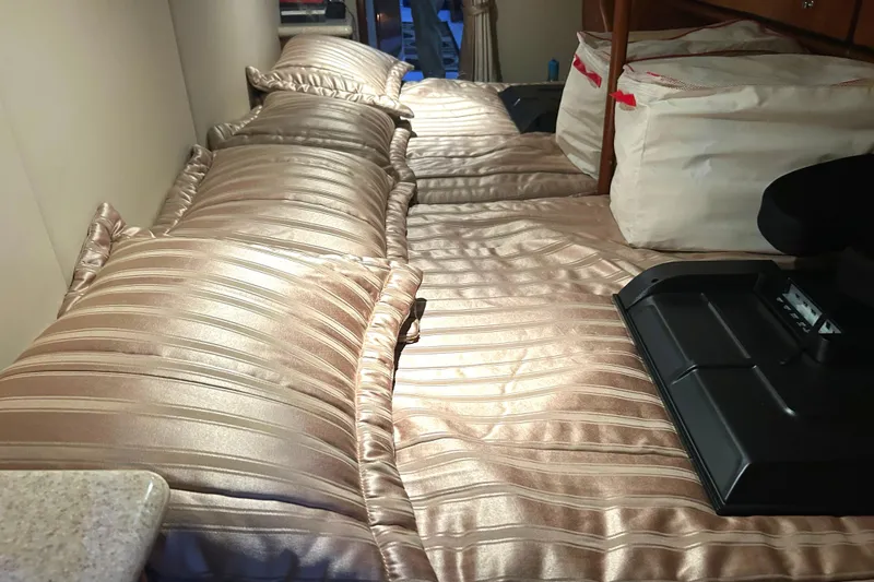 Slide: The Image of Luxurious interior of 2005 Fountain 48 Express Cruiser with satin bedding and storage. - 14