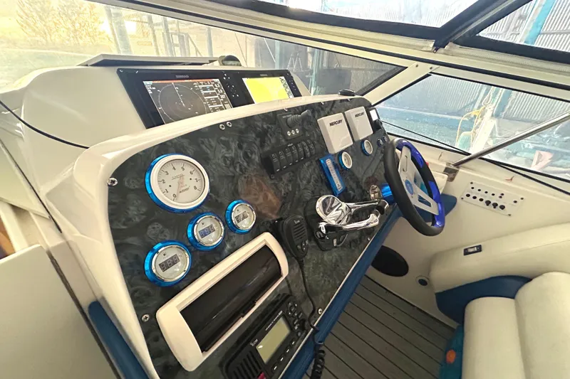 Slide: The Image of 2005 Fountain 48 Express Cruiser helm with gauges, controls, and navigation equipment. - 16
