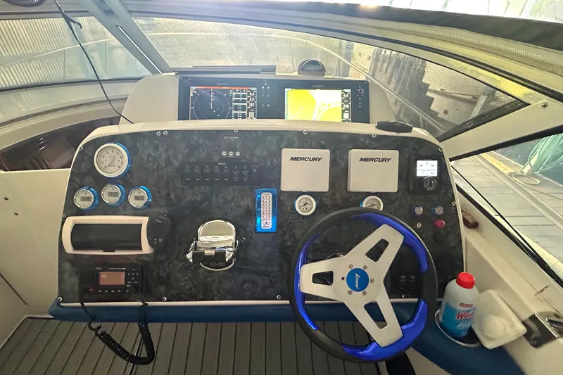 Slide: The Image of Helm of 2005 Fountain 48 Express Cruiser with navigation instruments and steering wheel. - 17