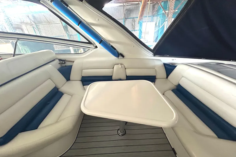 Slide: The Image of Interior of 2005 Fountain 48 Express Cruiser with white seating and table. - 20