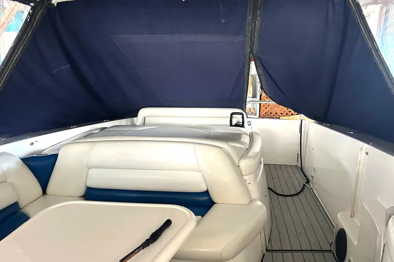 Slide: The Image of 2005 Fountain 48 Express Cruiser interior with white seating and blue canopy. - 21