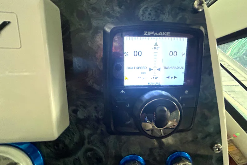 Slide: The Image of Control panel of a 2005 Fountain 48 Express Cruiser with Zipwake display. - 22