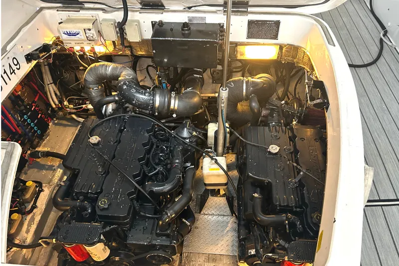 Slide: The Image of Engine compartment of a 2005 Fountain 48 Express Cruiser, showcasing dual engines and mechanical components. - 26