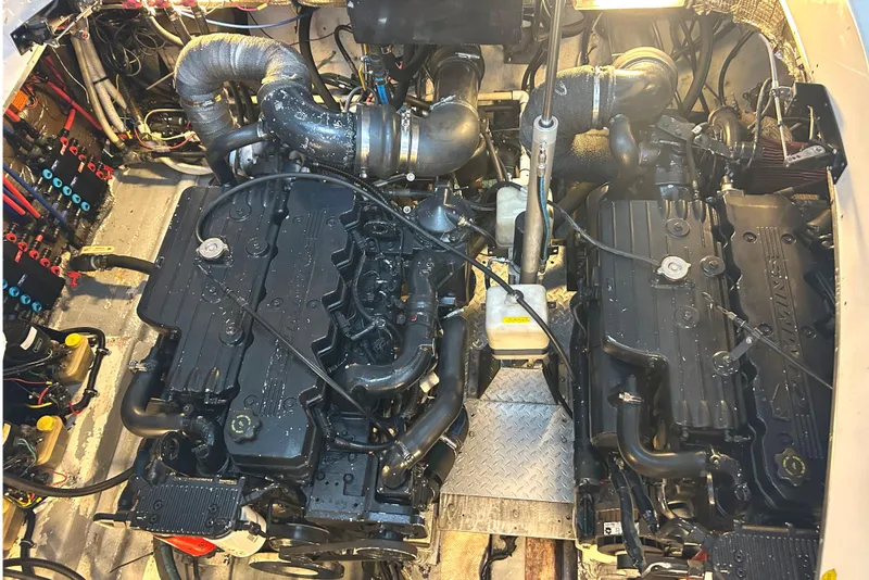 Slide: The Image of Engine room of a 2005 Fountain 48 Express Cruiser with dual engines and complex wiring. - 28