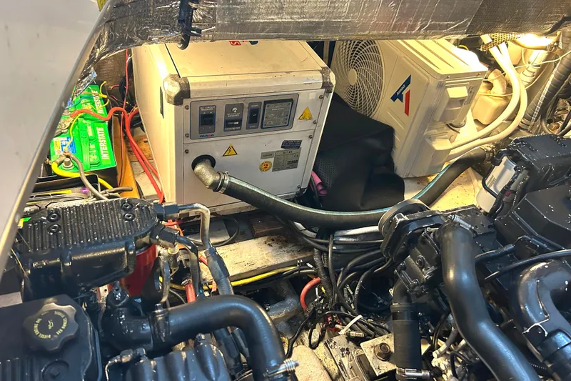 Slide: The Image of Engine room of a 2005 Fountain 48 Express Cruiser with generator and machinery. - 29