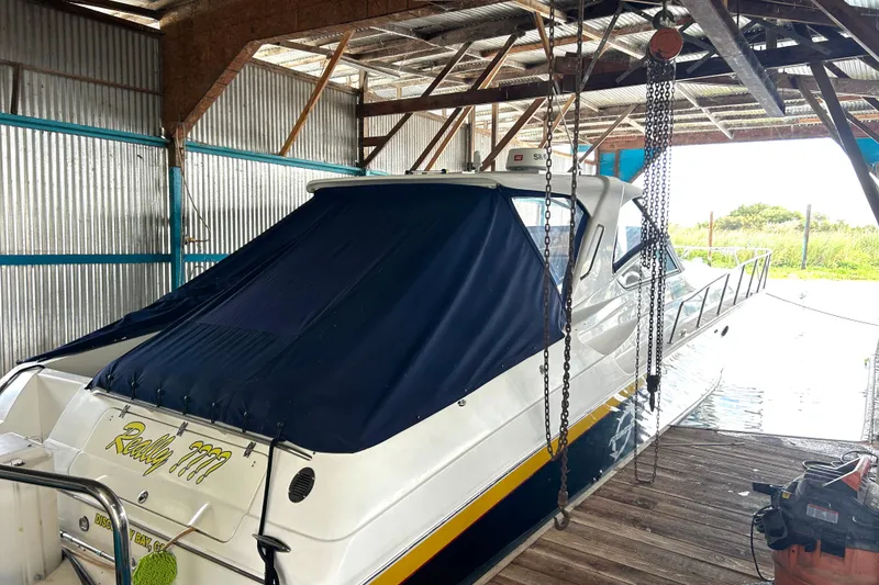 Slide: The Image of 2005 Fountain 48 Express Cruiser docked in a covered boathouse. - 3