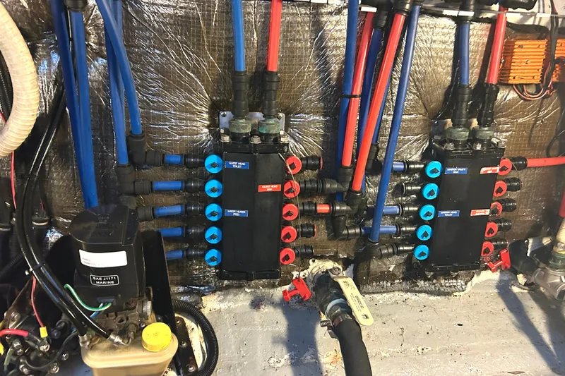 Slide: The Image of Engine room of 2005 Fountain 48 Express Cruiser with complex plumbing system. - 31