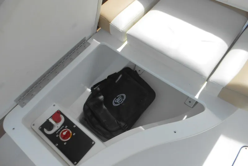 Slide: The Image of Storage compartment in a 2015 Cobalt 296 boat with safety equipment. - 10
